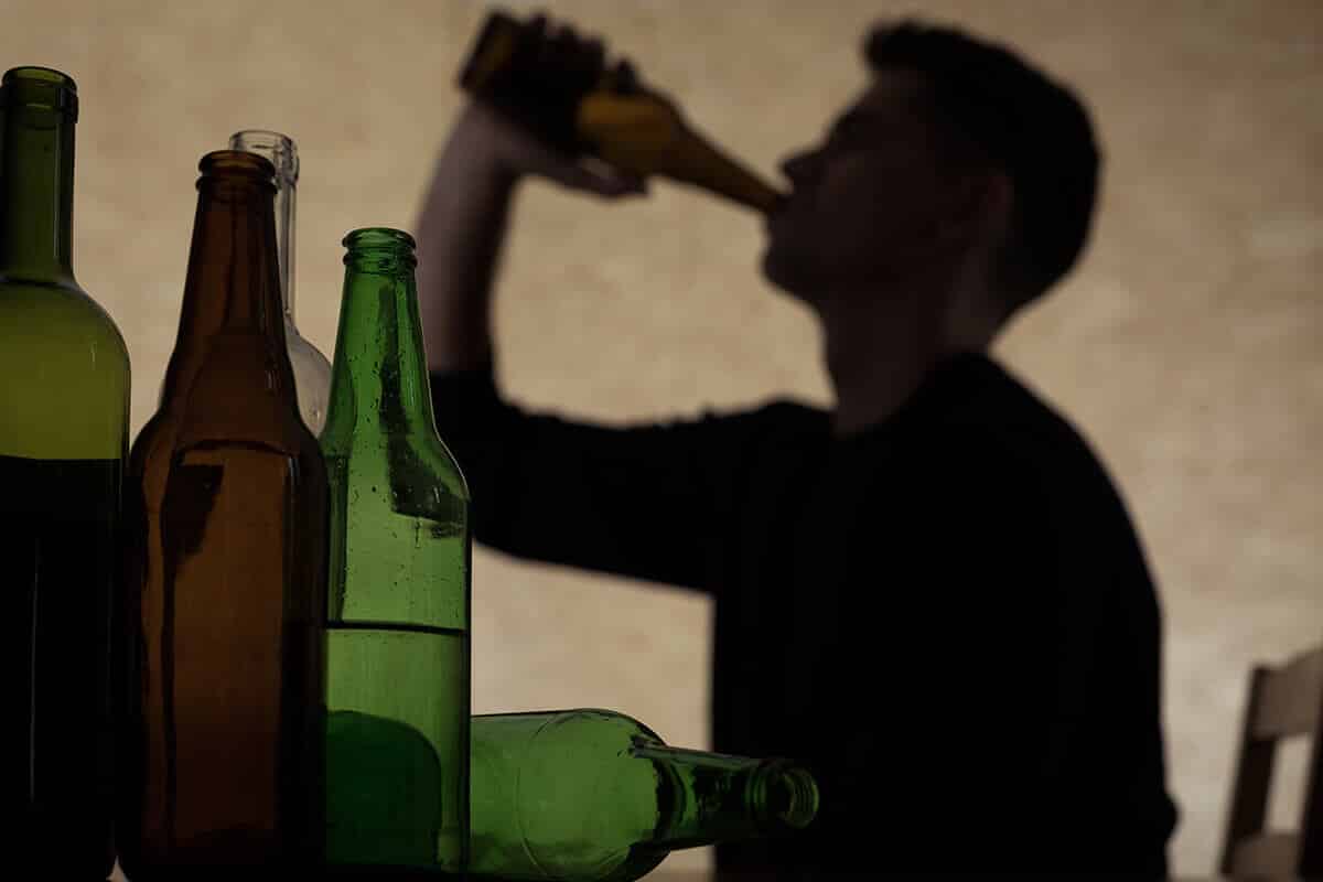 man thinking about signs of alcoholism
